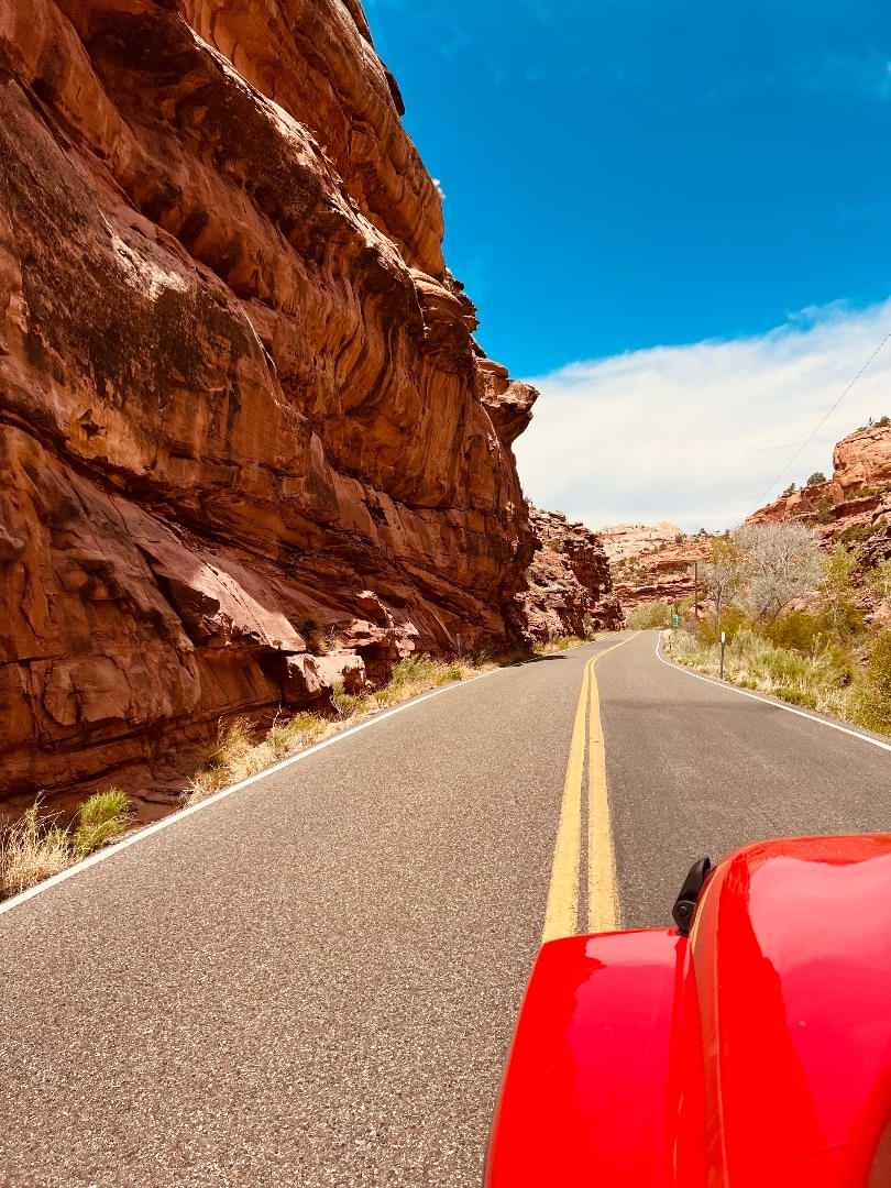 Red Jeep on an adventure tour through winding Utah canyons