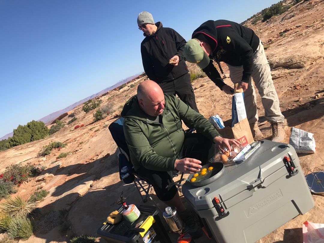 Preparing eggs for breakfast in the outdoor camp kitchen