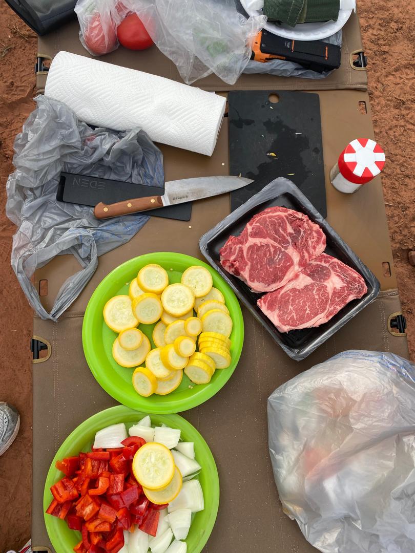 Fresh steak and vegetables being prepared at the camp