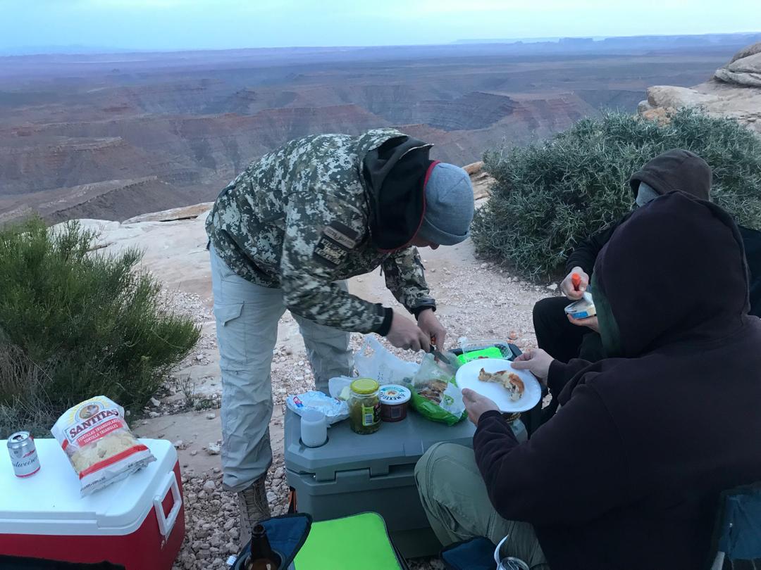 Camp meal preparation with view into a Southwest canyon