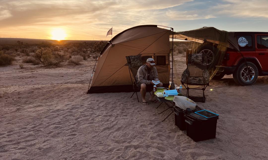Camp setup at sunset with Jeep and tent