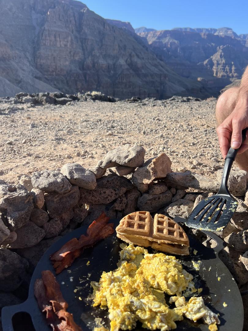 Breakfast with eggs, bacon, and waffles in canyon view