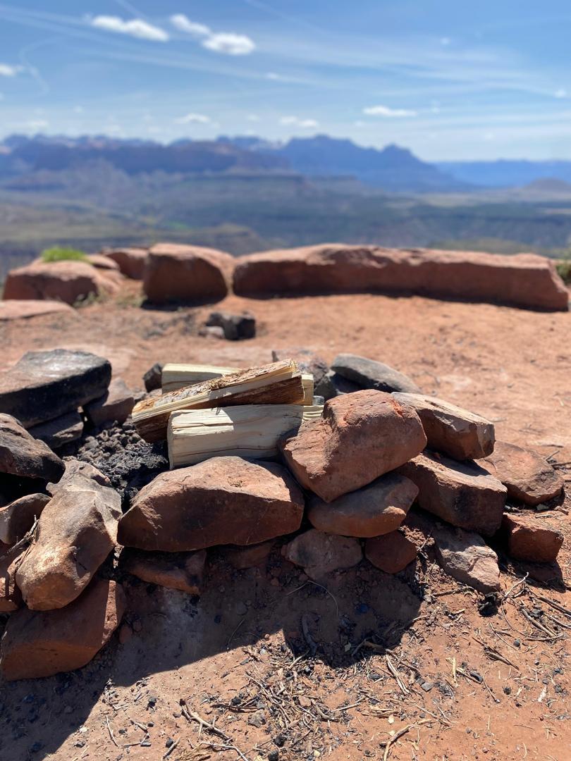 Campfire pit prepared with wood at a scenic overlook