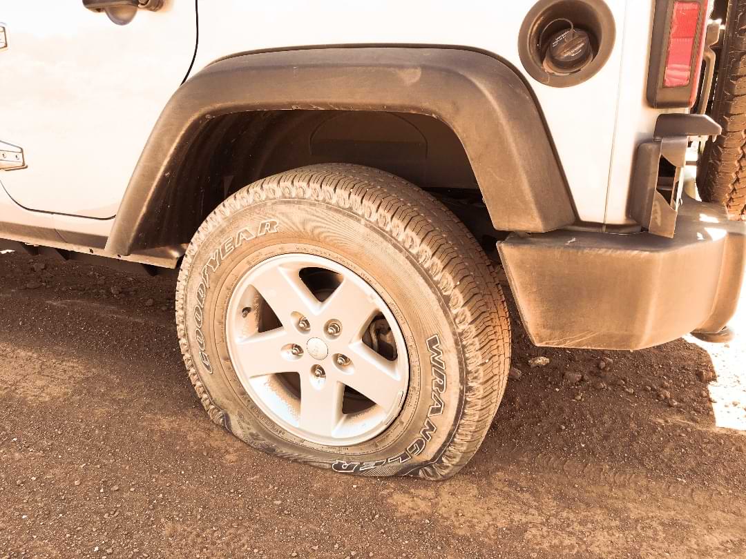 Flat tire on Jeep in desert trail