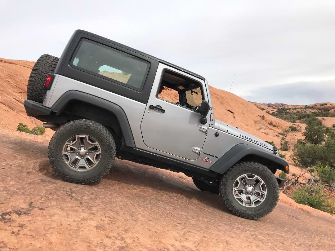 Jeep Rubicon descending Moab slickrock