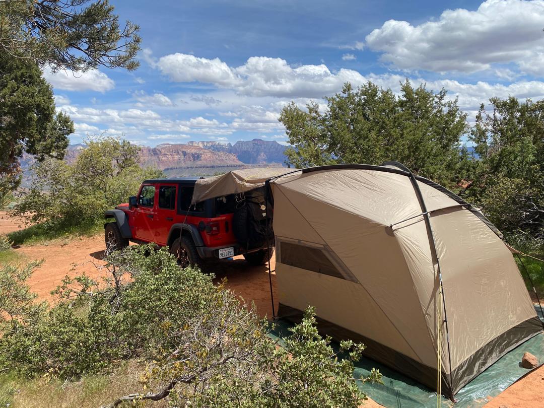 Jeep and tent setup at scenic mountain camp