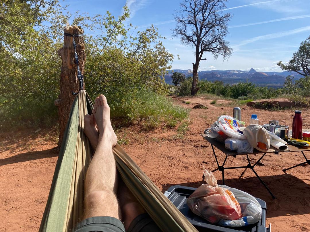 Camper relaxing in hammock with mountain view