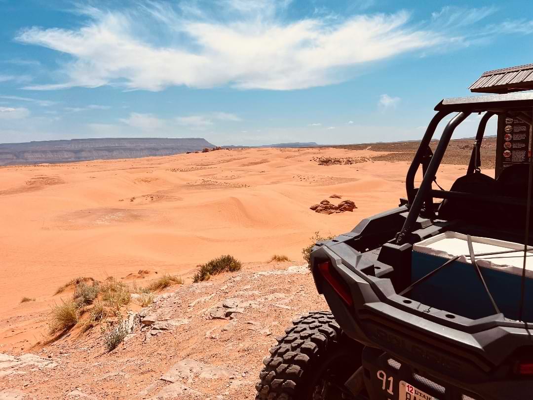 Side-by-side vehicle overlooking Utah sand dunes