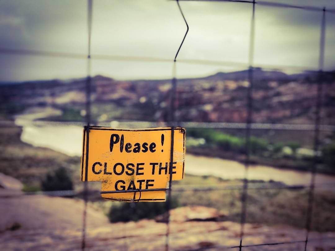 Trail etiquette sign to close the gate in desert