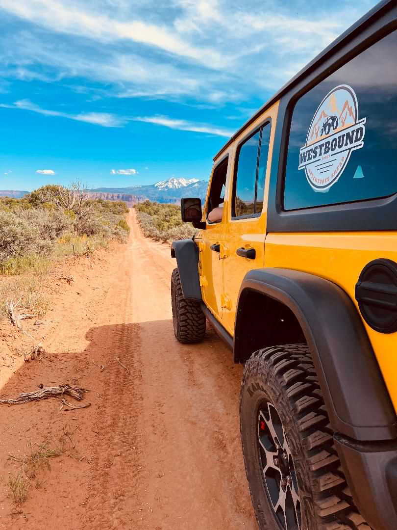 Yellow Jeep on rugged desert trail during offroad adventure in the Southwest